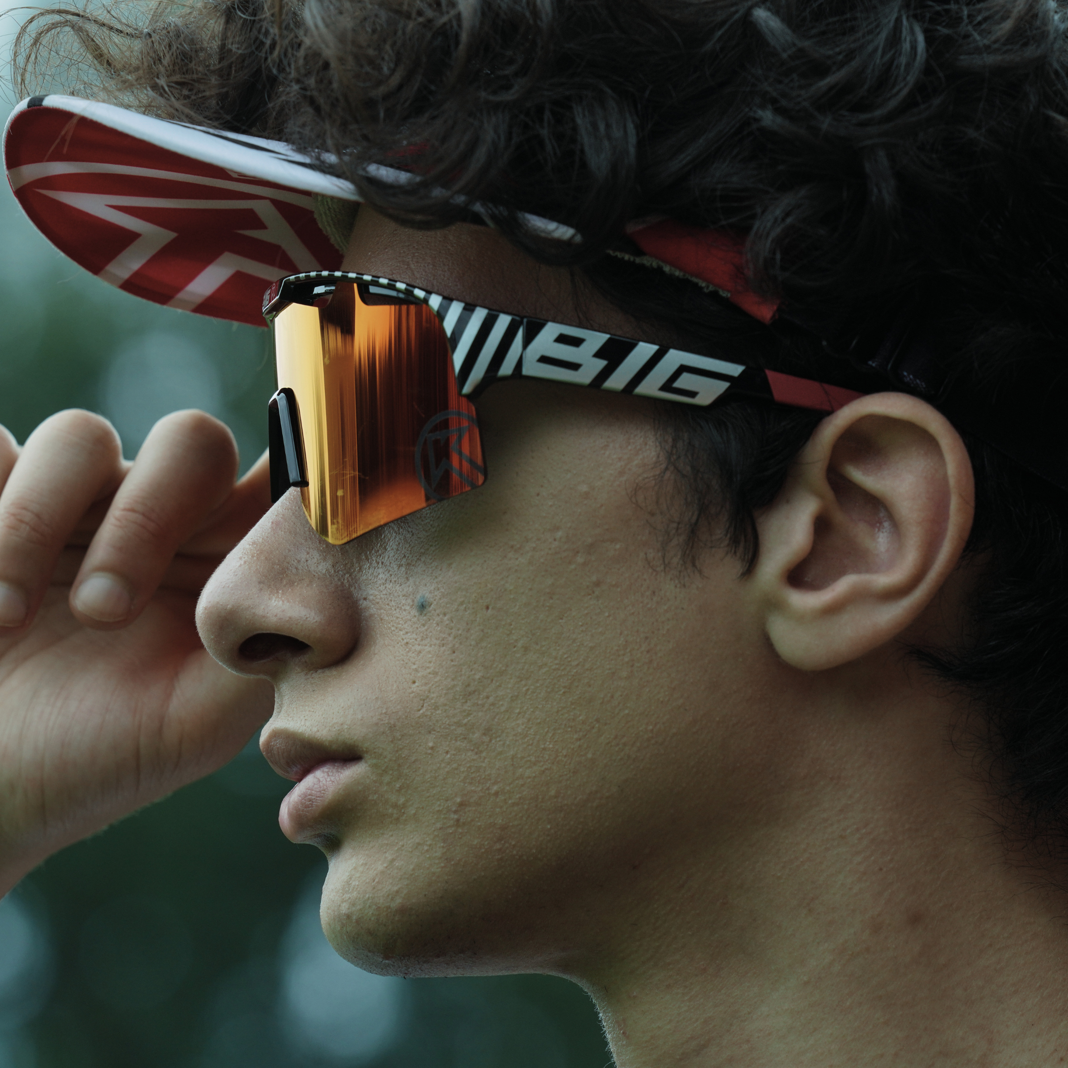 Person wearing a helmet with a brand logo and reflective sunglasses.