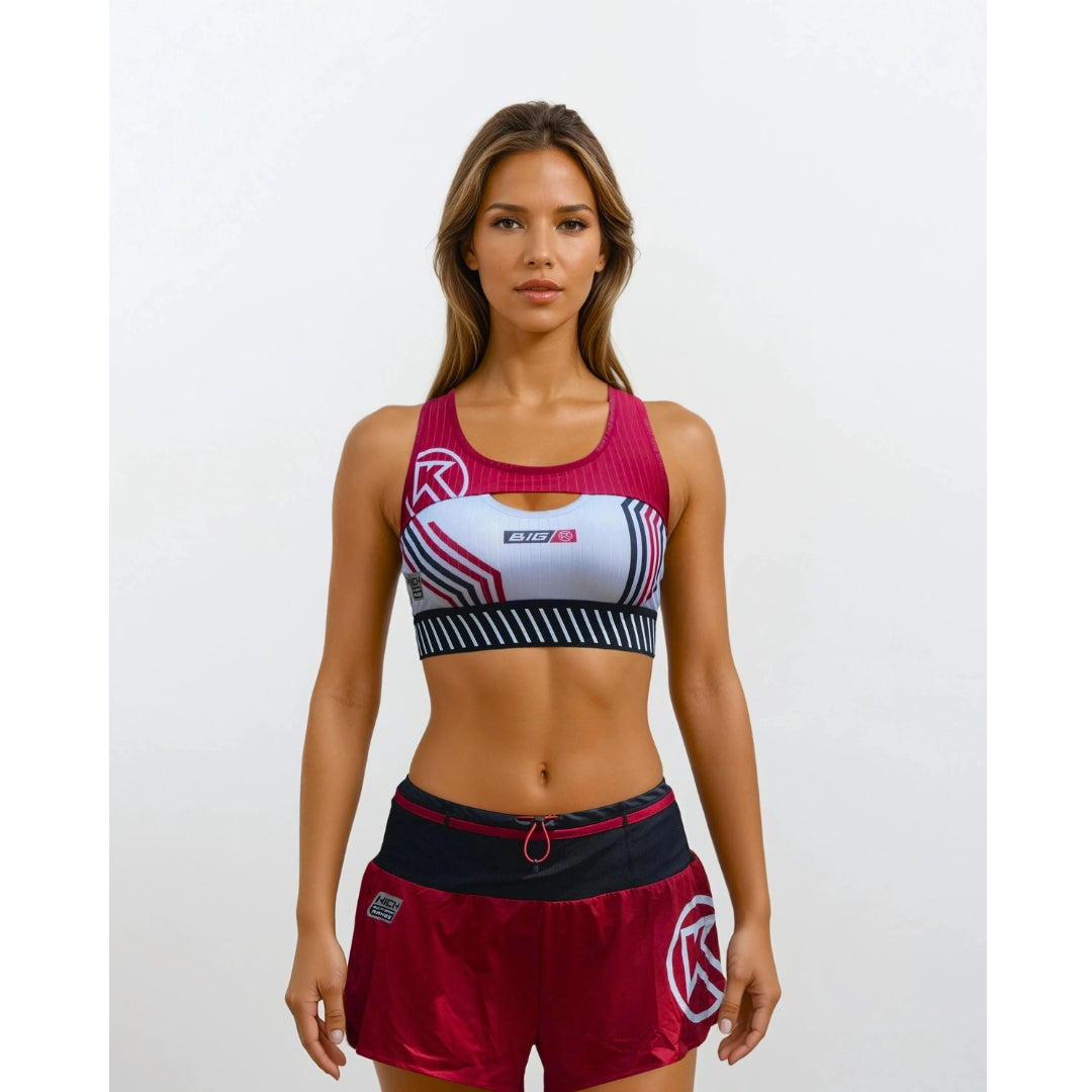 Woman wearing a sports bra and shorts with a brand logo on a white background