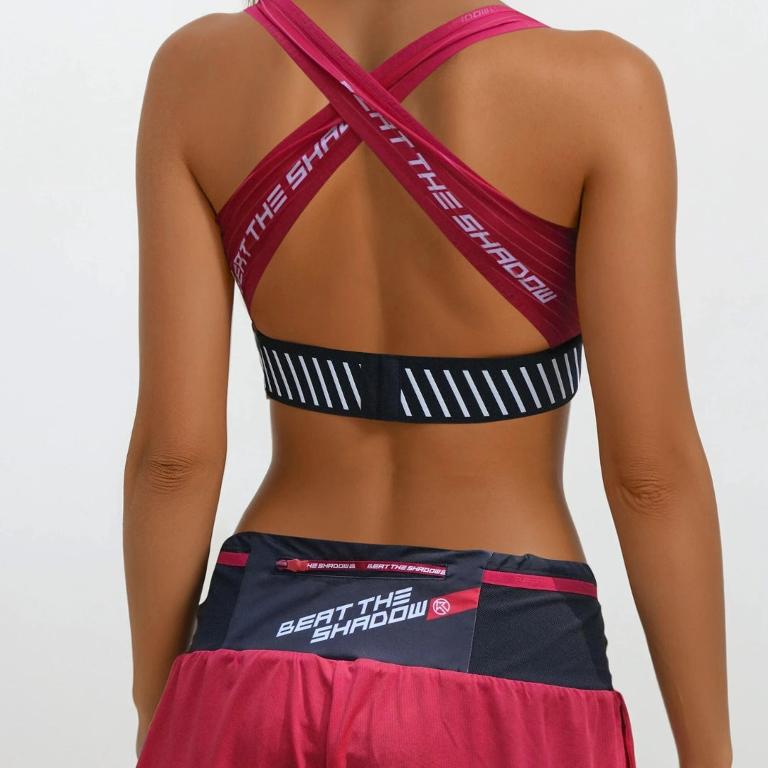 Athletic outfit with sports bra and shorts featuring 'Beat the Shadow' branding on a plain background.