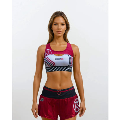 Woman wearing a sports bra and shorts with a brand logo on a white background