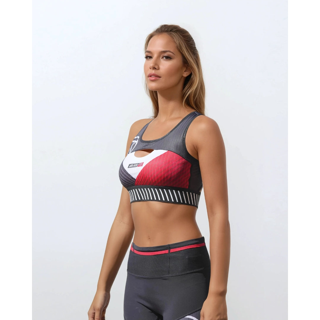 Woman wearing a sports bra and leggings with a colorful design on a white background