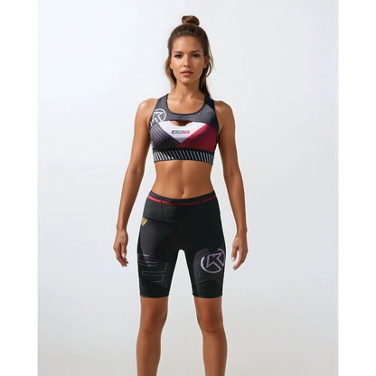 Woman wearing a sports bra and shorts with a brand logo on a white background